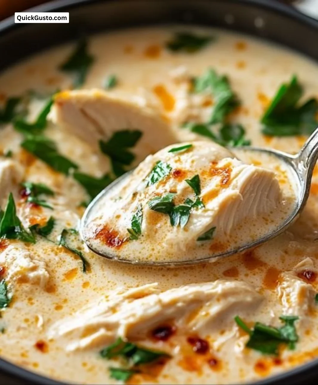 Delicious Chicken Parmesan Soup garnished with basil in a bowl