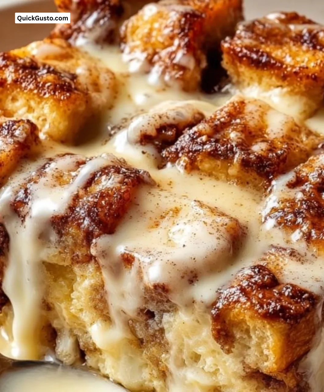 Deliciously baked cinnamon roll bread pudding served in a dish