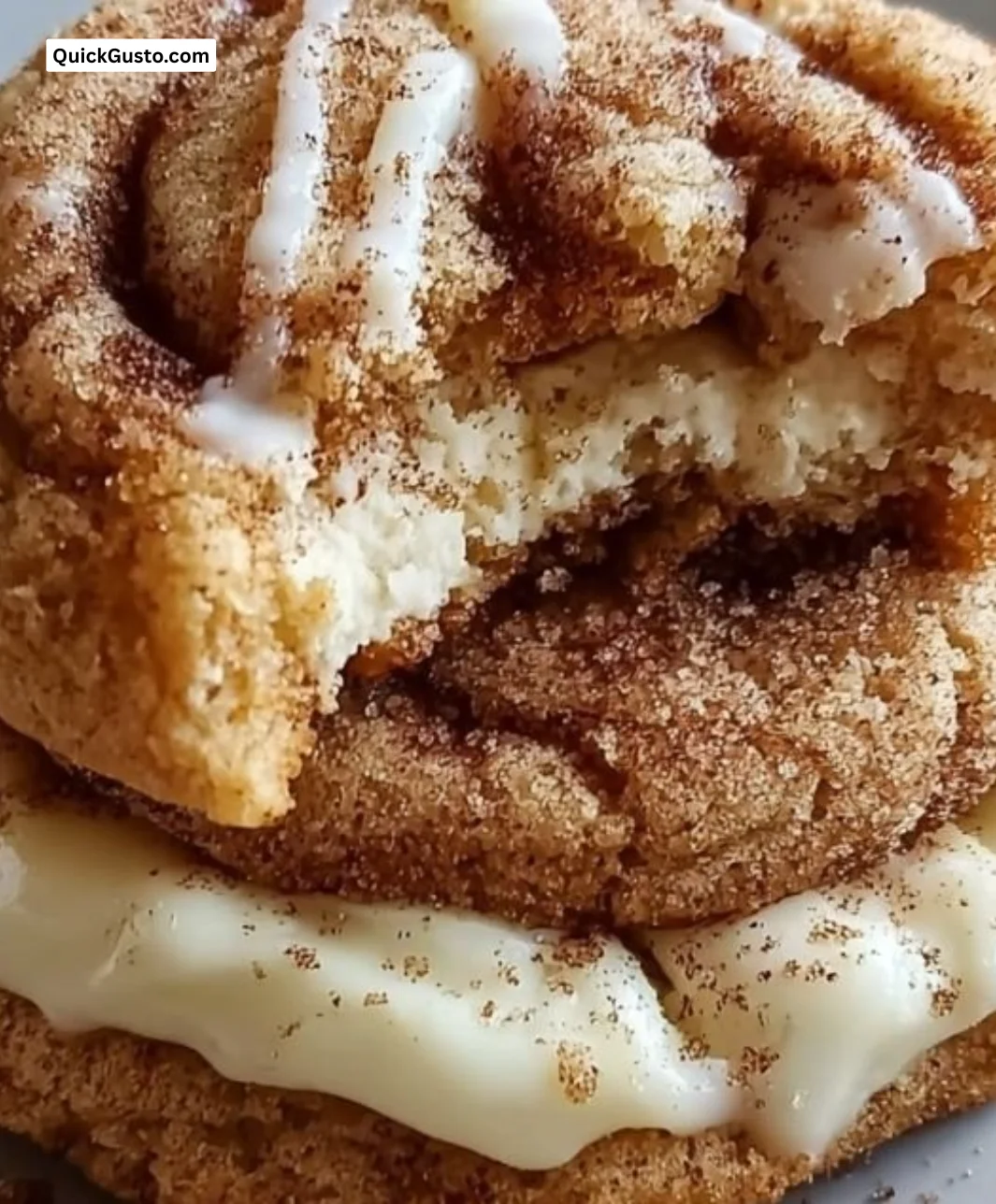 Cinnamon roll cheesecake cookies with cinnamon swirl topping on a plate