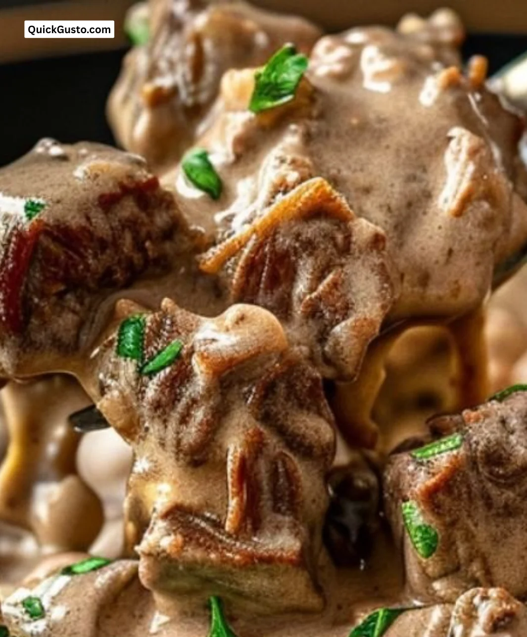 Classic beef stroganoff served over noodles with mushrooms and creamy sauce.