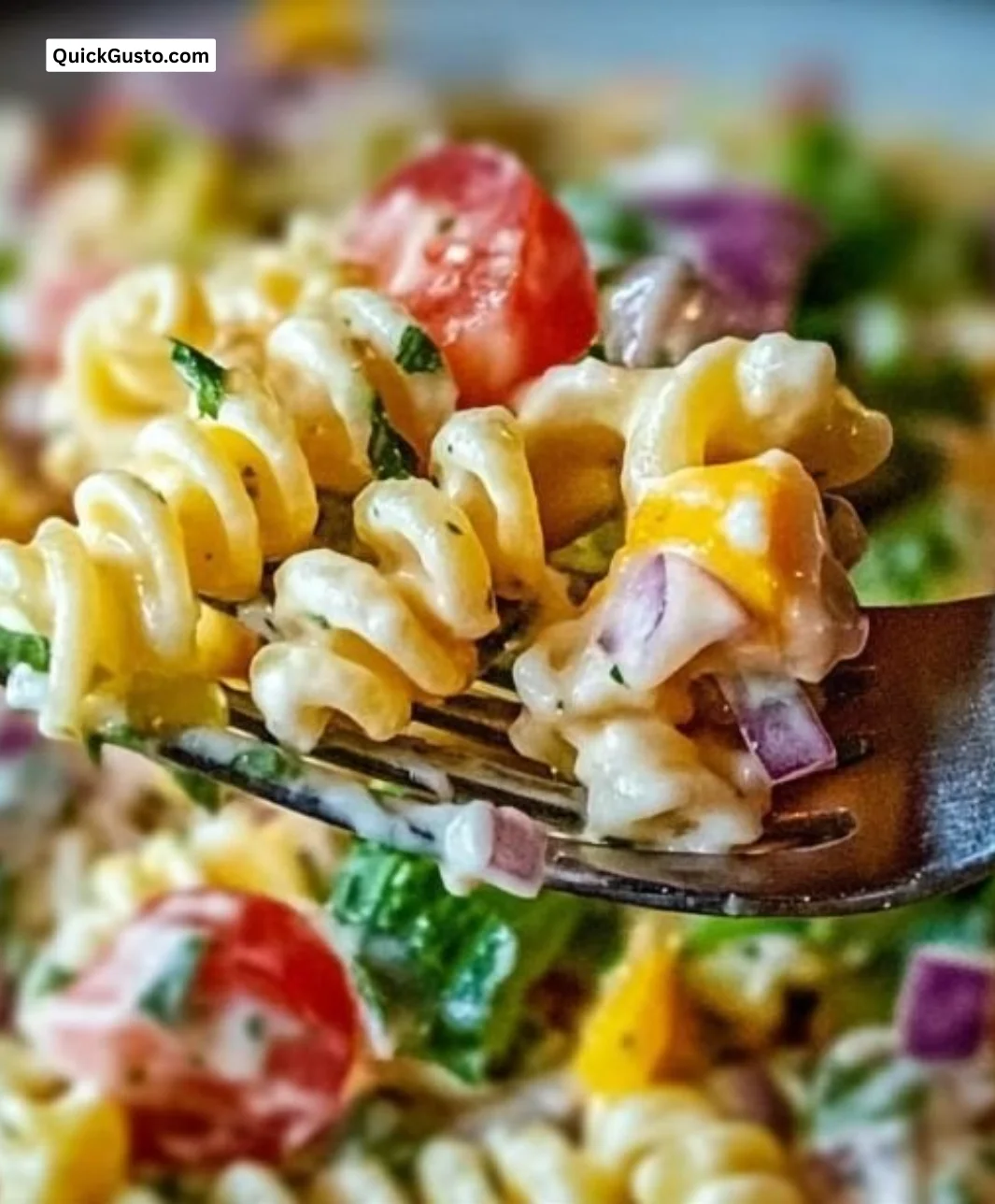 A vibrant bowl of Club Sandwich Pasta Salad with layers of ingredients, ideal for summer picnics.