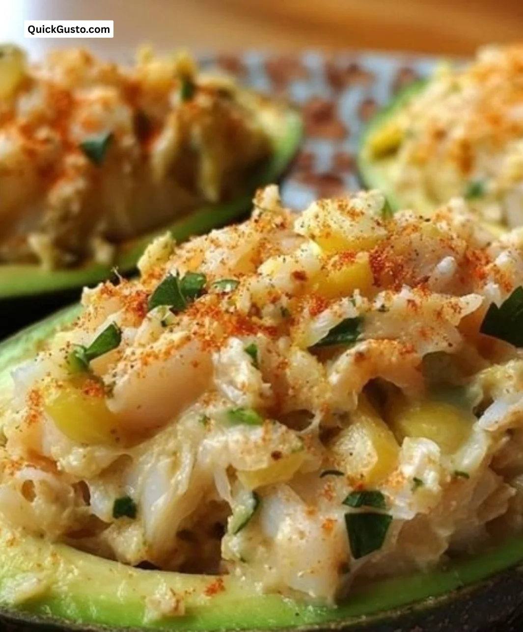 Delicious crab-stuffed avocado served on a plate with garnish.