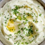 Creamiest mashed cauliflower dish garnished with herbs