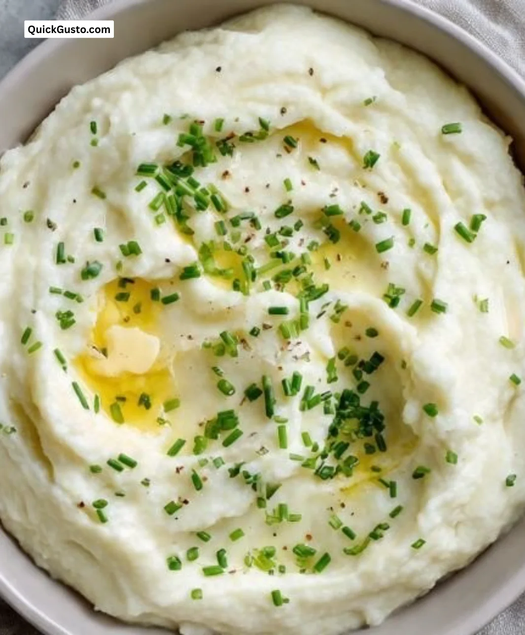 Creamiest mashed cauliflower dish garnished with herbs