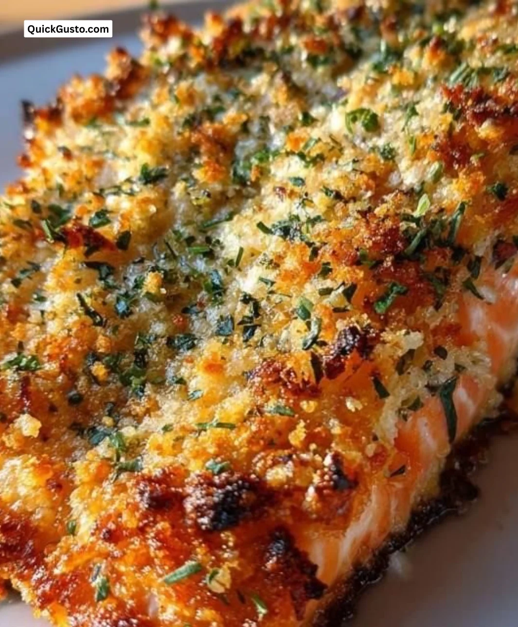Crispy parmesan salmon bake served on a plate with herbs