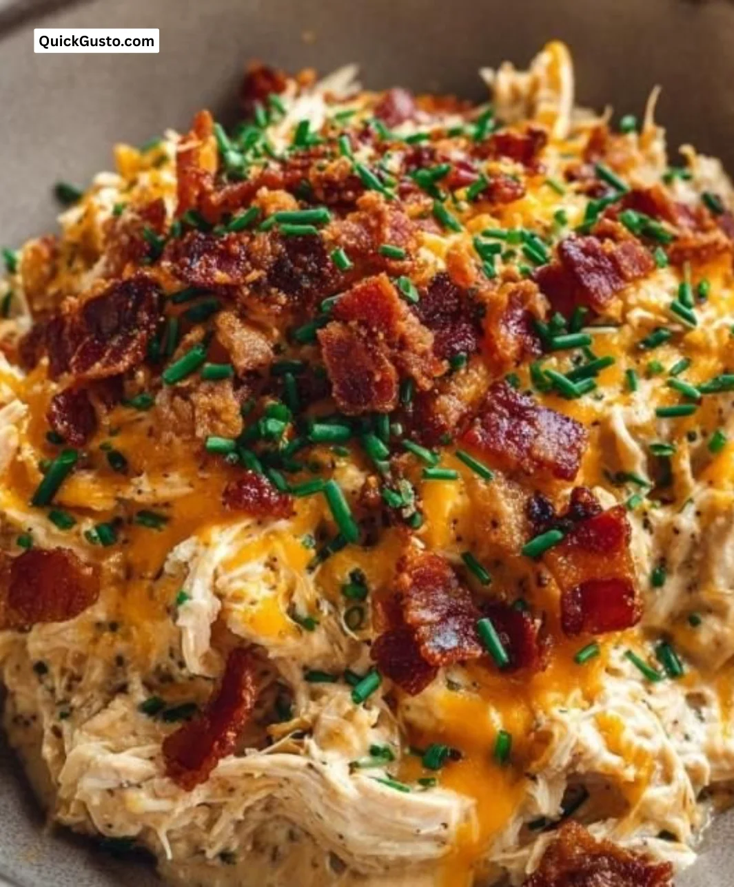 Crockpot Crack Chicken served in a bowl with herbs and spices