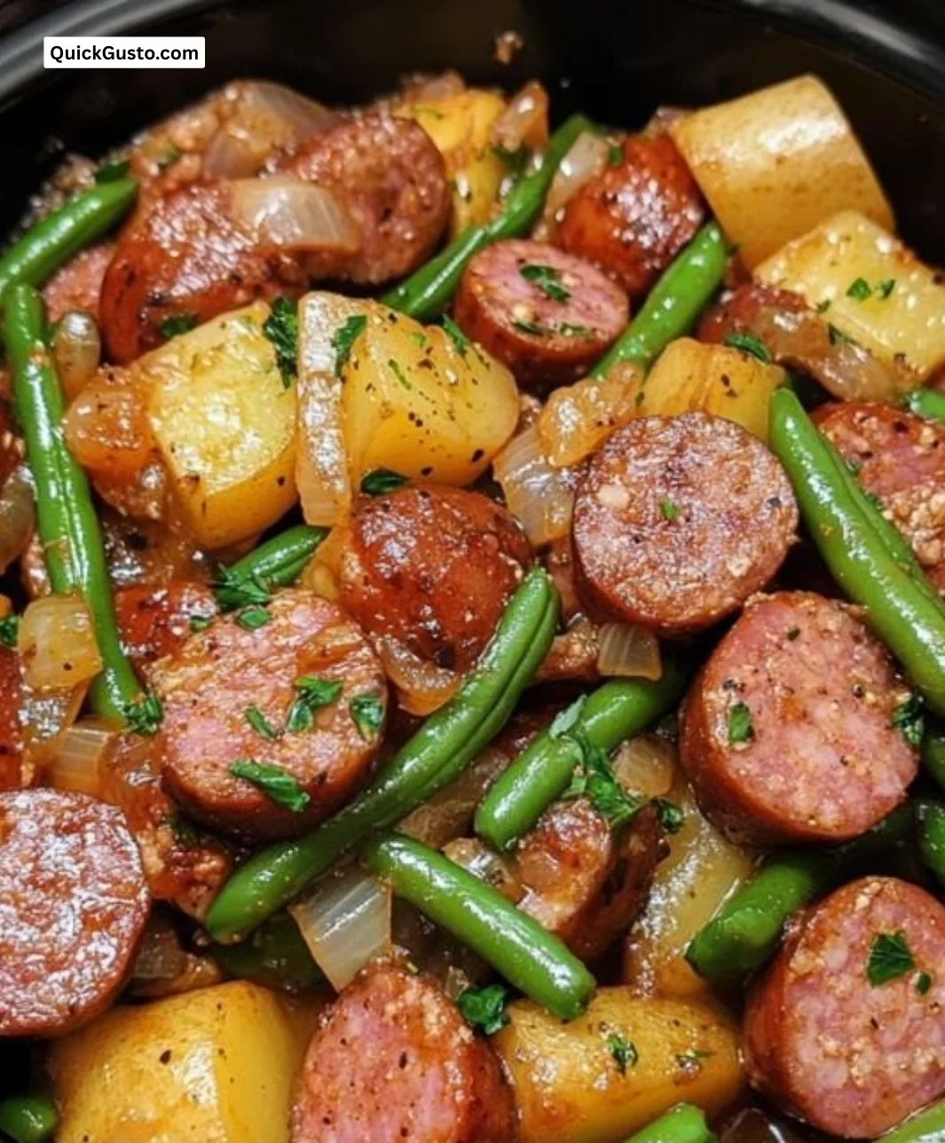 Crockpot kielbasa served with green beans in a slow cooker, a hearty meal.