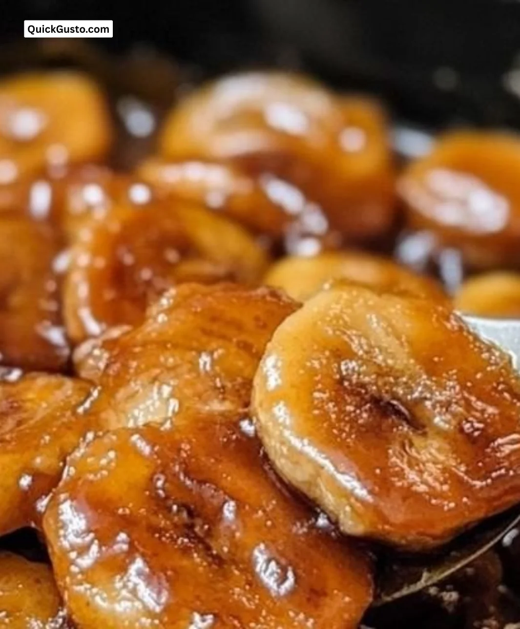 Plate of easy caramelized banana slices drizzled with caramel sauce.