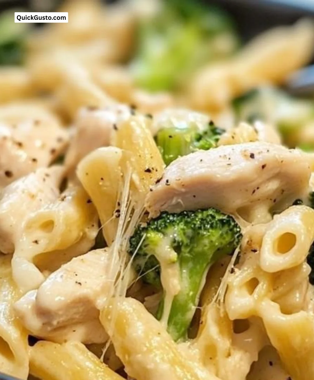 Creamy chicken alfredo pasta with broccoli in a white bowl