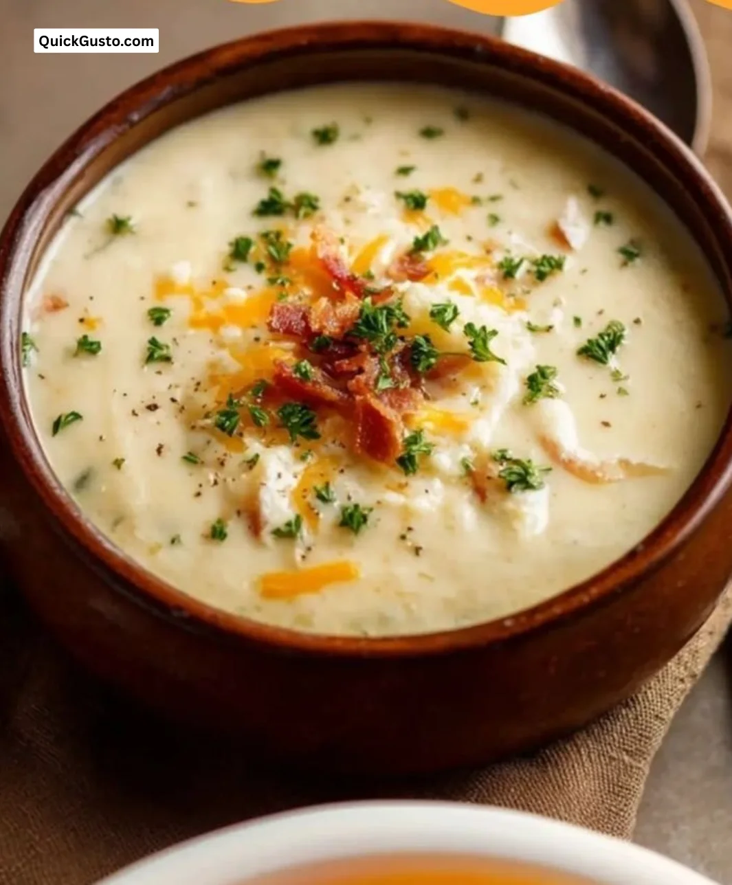 Bowl of easy potato soup garnished with herbs and croutons