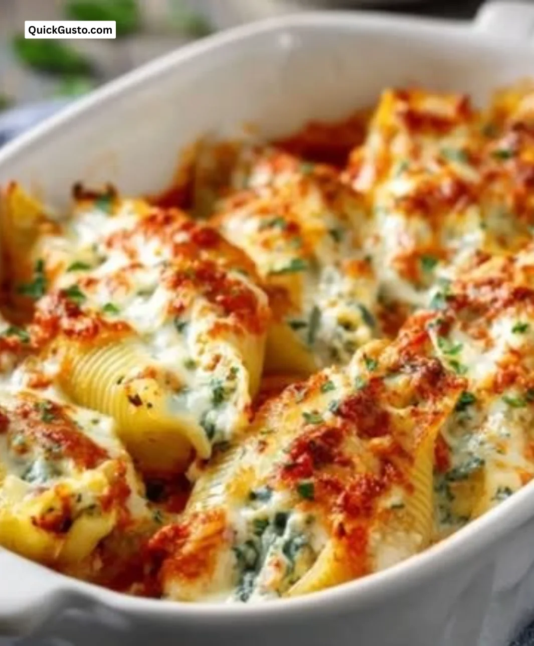 Plate of easy stuffed shells filled with cheese and topped with sauce