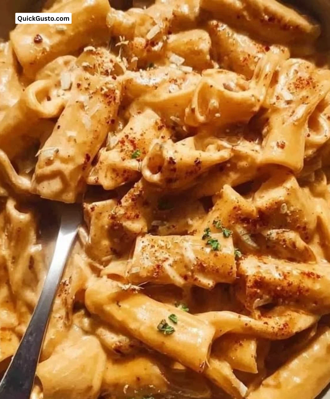 Bowl of creamy French Onion Pasta topped with cheese and caramelized onions