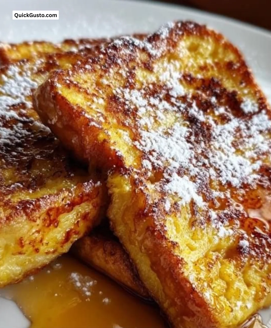 Delicious golden-brown French Toast served with syrup and fresh fruit