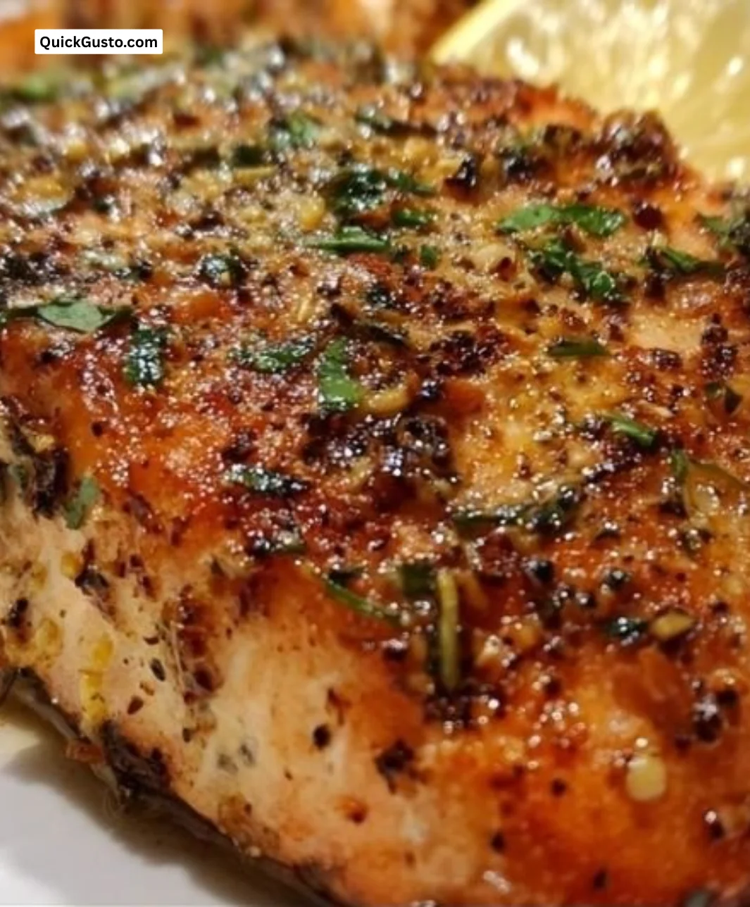 Delicious Garlic Lemon Roasted Salmon garnished with herbs and lemon slices.
