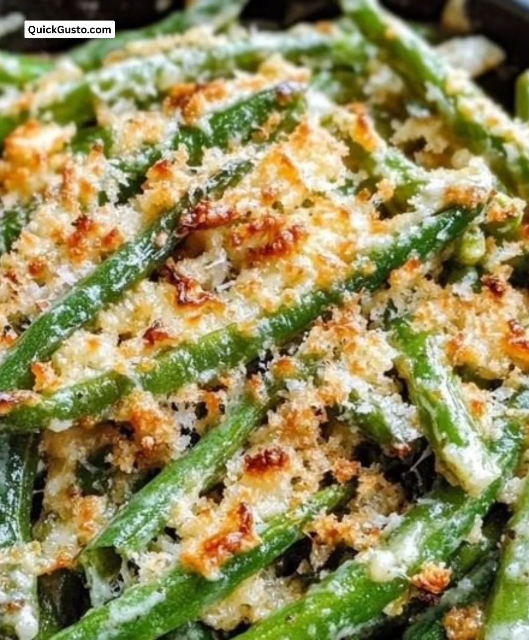 Plate of Garlic Parmesan Green Beans garnished with cheese and herbs.