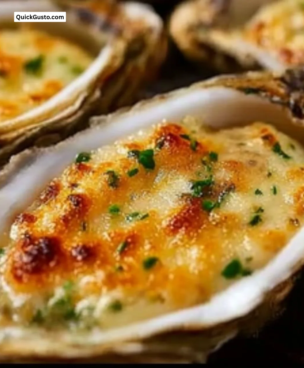 Delicious Grilled Parmesan Garlic Oysters topped with cheese and herbs