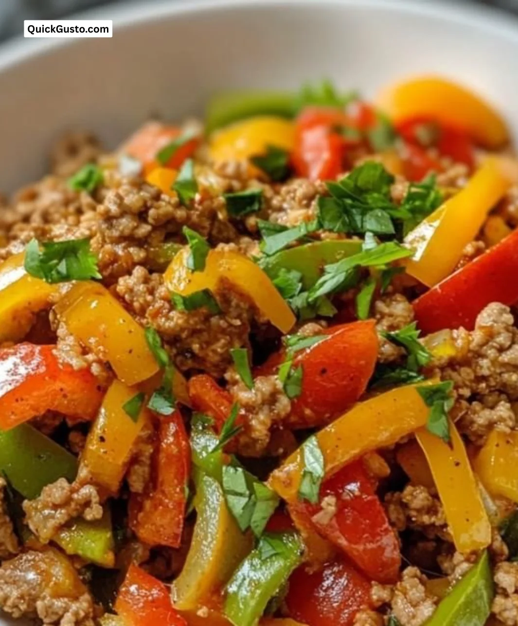 Ground turkey stir-fry with colorful bell peppers in a skillet