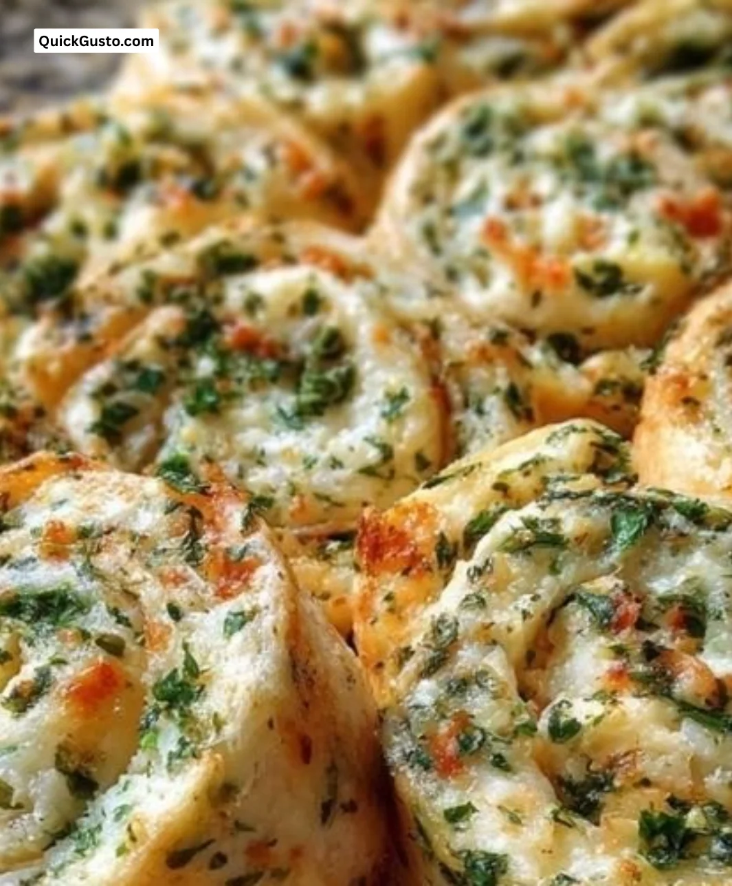 Herbed cream cheese pinwheels served on a platter.