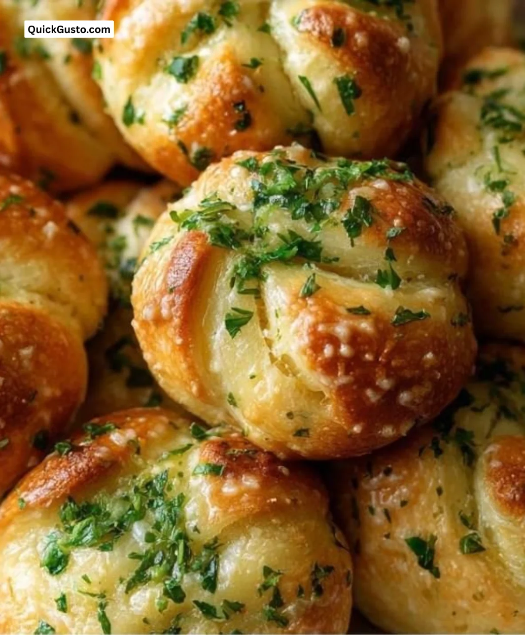 Freshly baked homemade garlic knots with herbs and butter