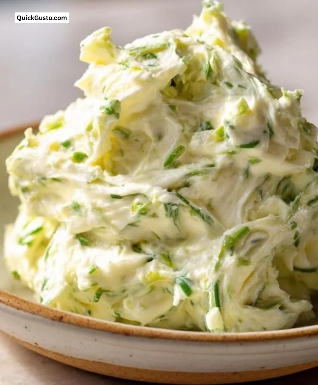 Homemade garlic scape compound butter on a wooden board
