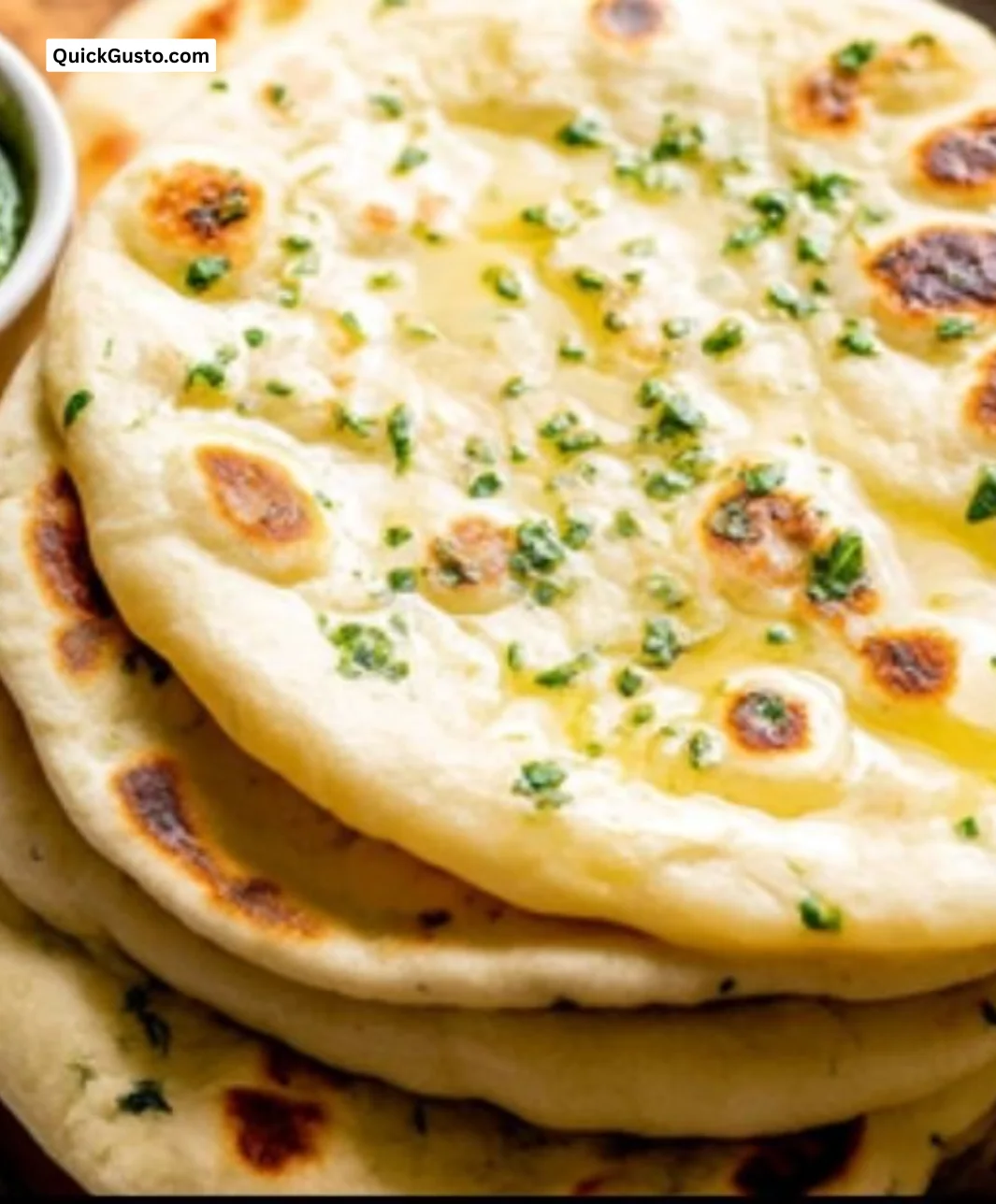 Freshly made homemade naan bread on a wooden board