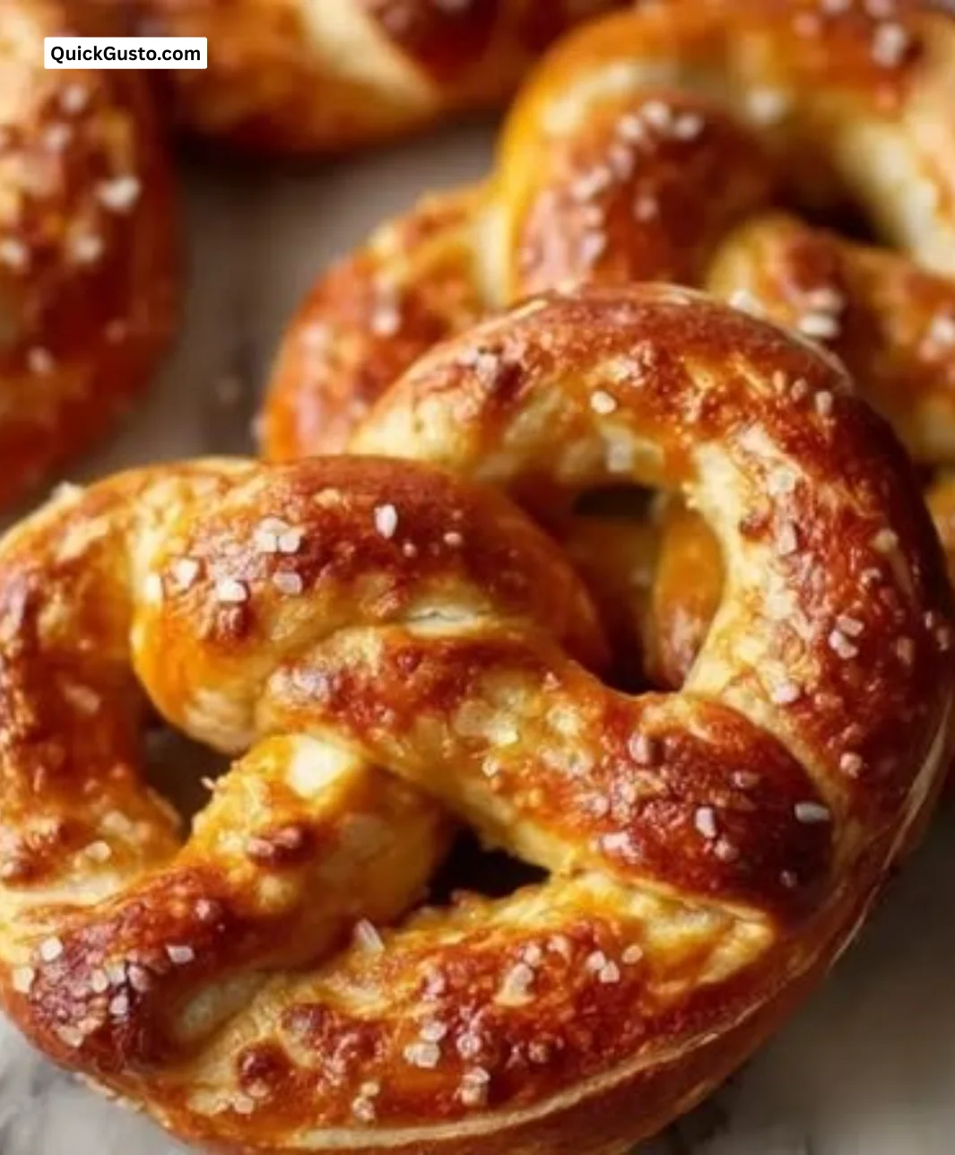 Freshly baked homemade soft pretzels with salt on a wooden board