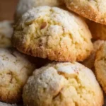Freshly baked Italian almond sugar cookies on a cooling rack.