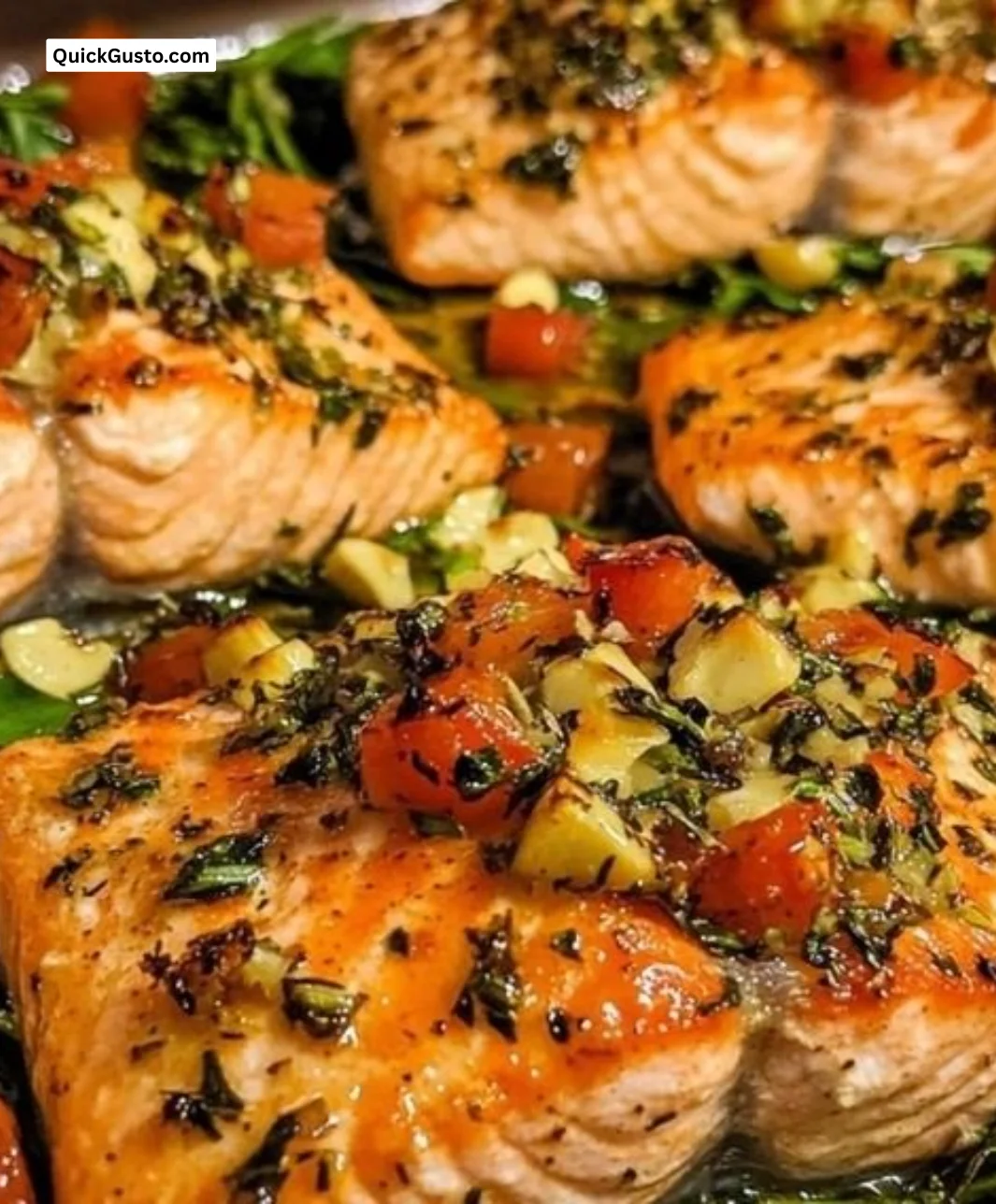 Italian Herb Baked Salmon garnished with fresh herbs and lemon on a plate.