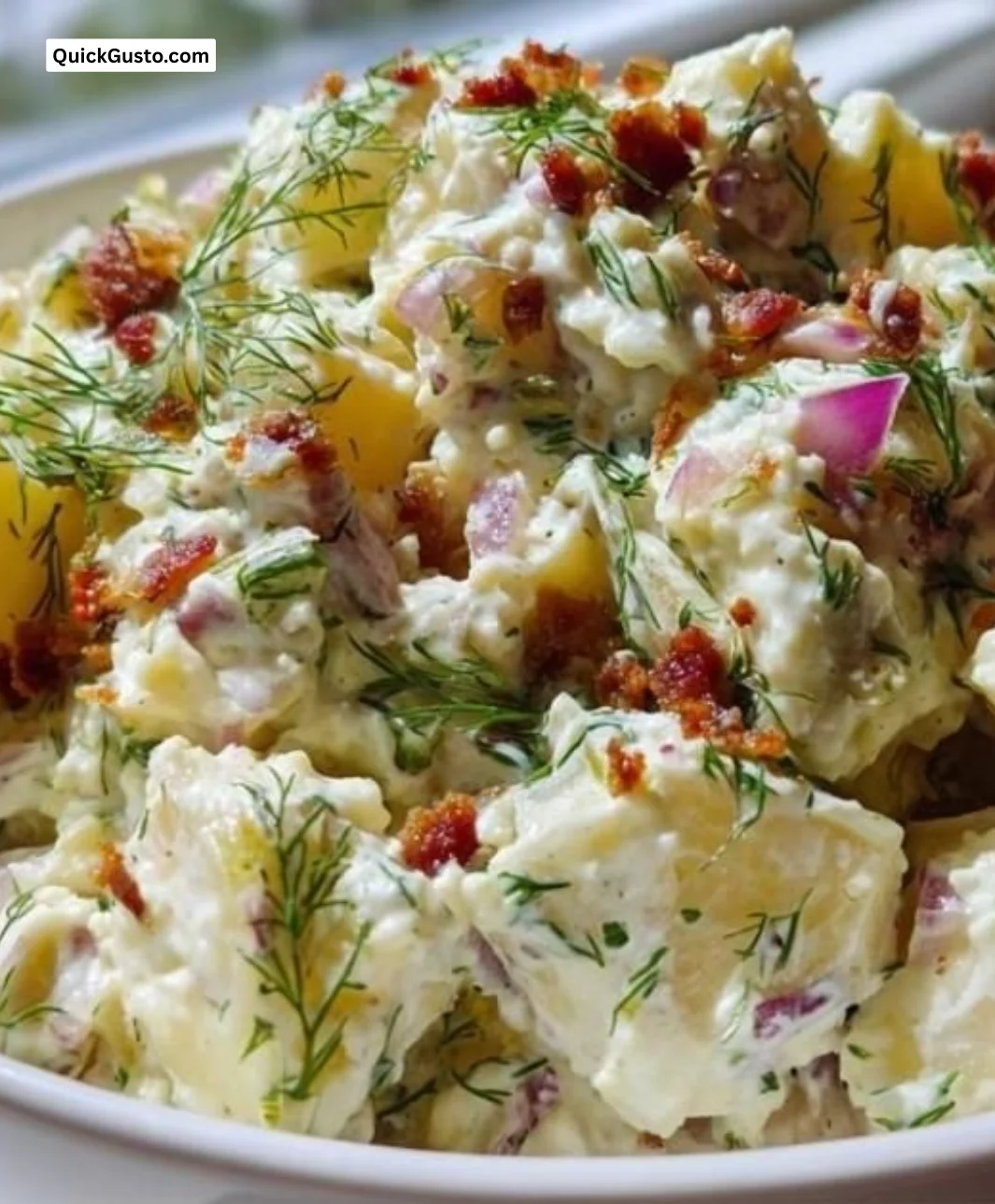 Bowl of keto potato salad with fresh vegetables and herbs