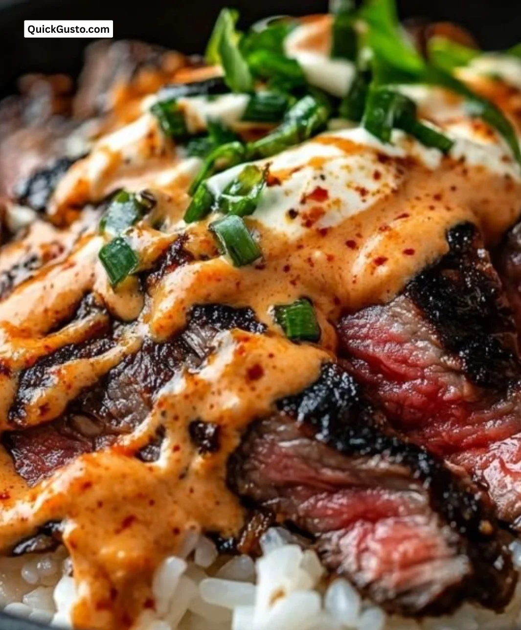 Delicious Korean BBQ steak rice bowl garnished with fresh vegetables.