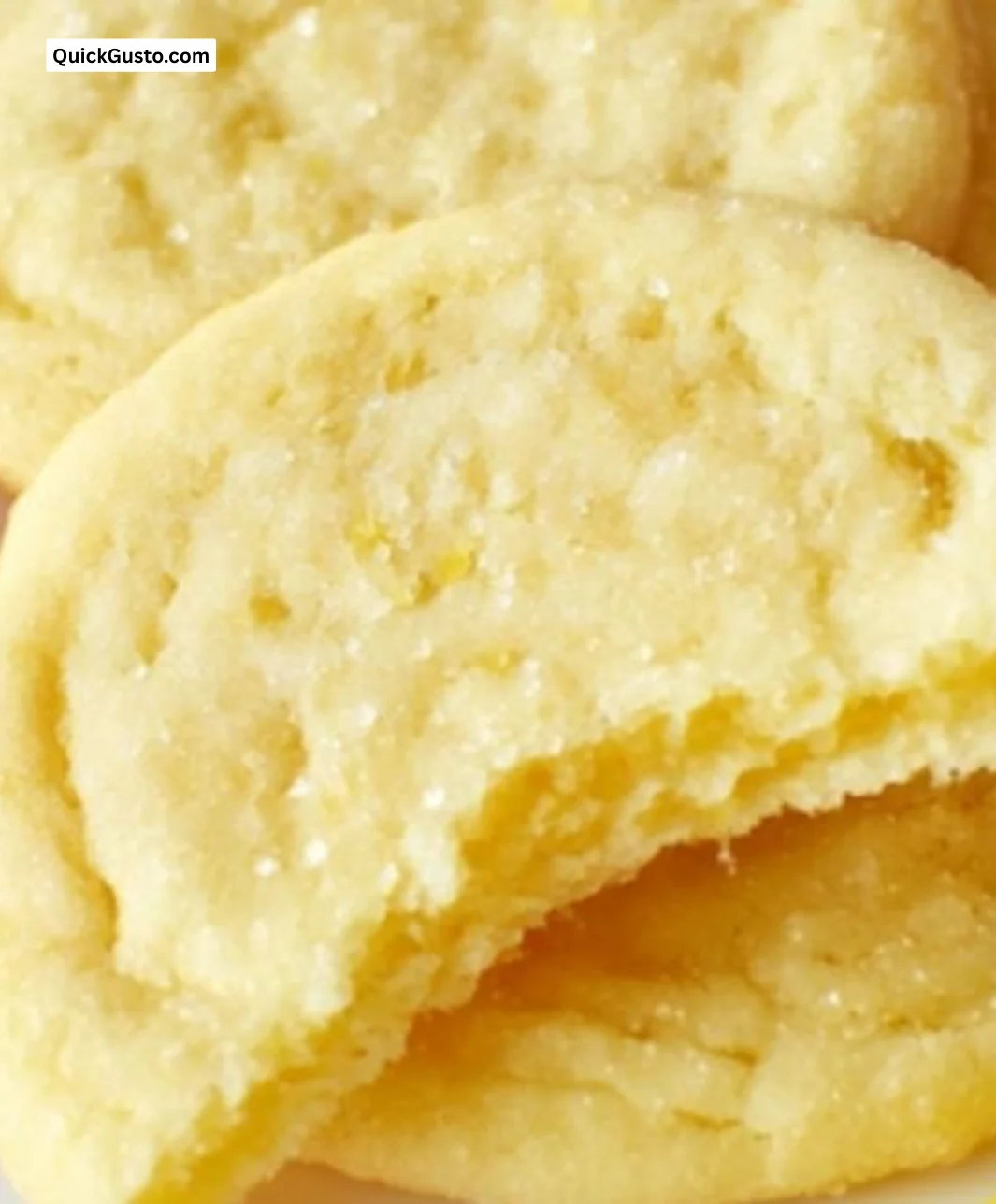 Delicious lemon sugar cookies with a zesty frosting on a plate.