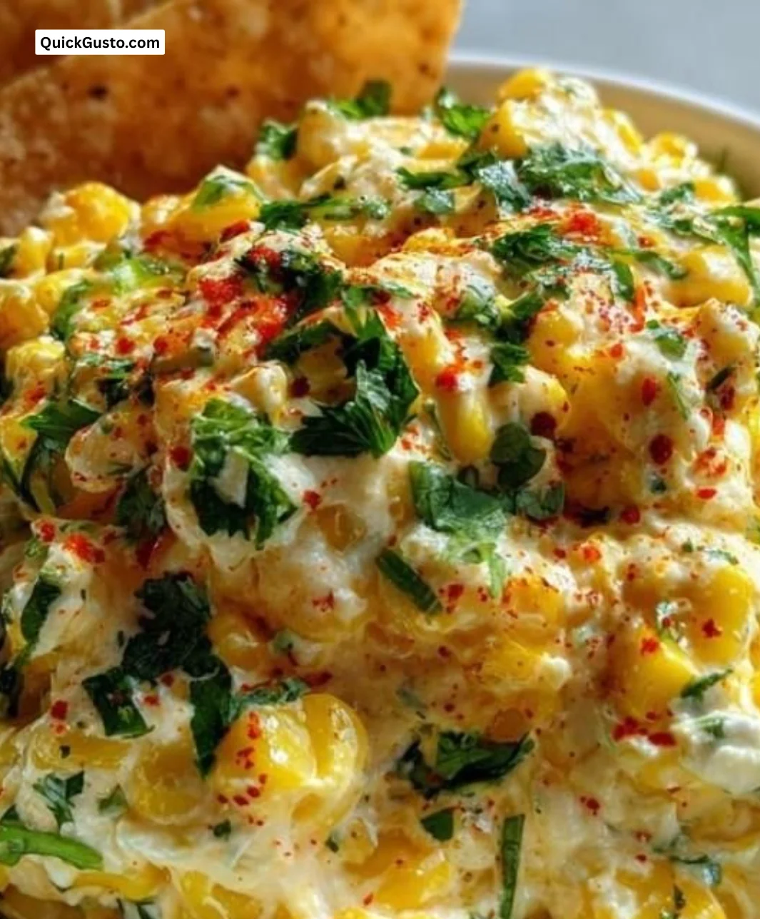 Creamy Mexican street corn dip served in a bowl with fresh toppings