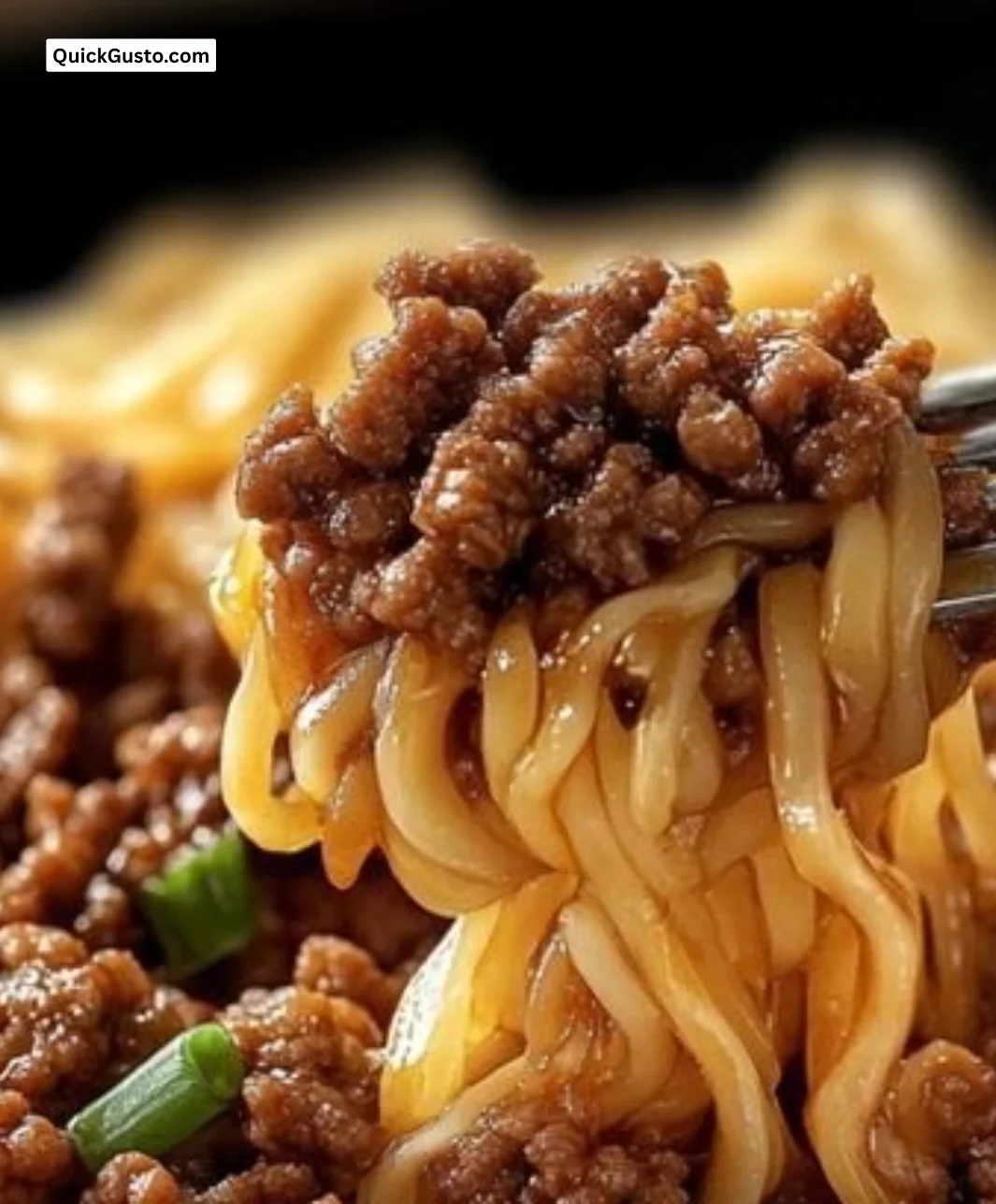 Mongolian Ground Beef Noodles garnished with green onions and red peppers.