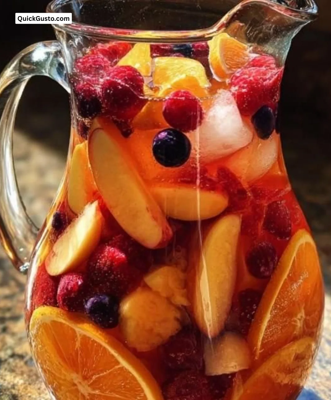 Delicious Peach Berry Sangria in a chilled glass with fresh fruit slices.