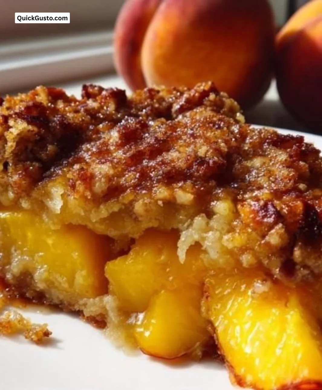 Delicious Peach Cobbler with a crunchy Pecan Crust served in a dish.