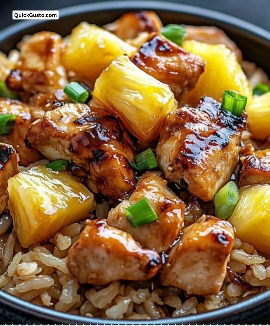Plate of Pineapple Chicken and Rice garnished with fresh herbs