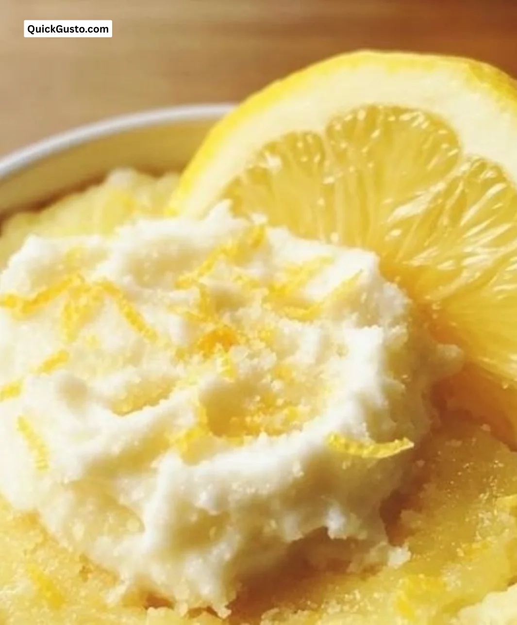 Delicious quick lemon mug cake topped with lemon zest in a mug