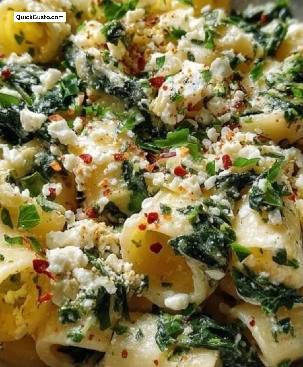 A bowl of quick spinach and feta pasta with fresh ingredients.