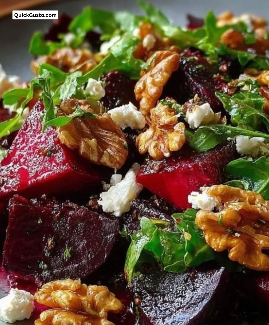 Roasted beet and walnut salad garnished with greens and vinaigrette.