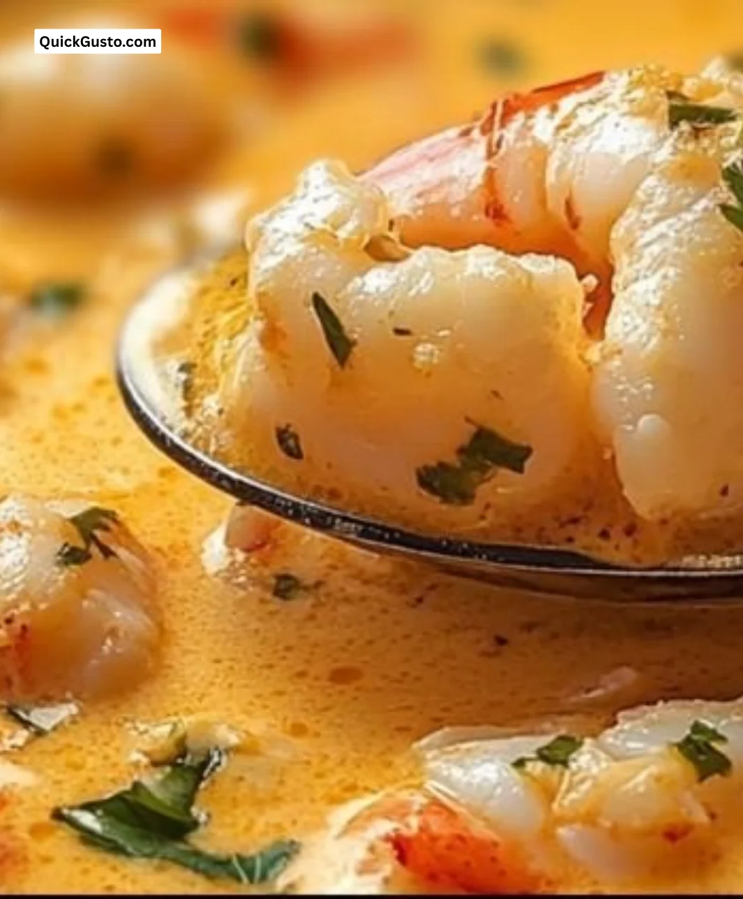 Bowl of creamy Seafood Bisque with crab, shrimp, and lobster garnished with herbs.