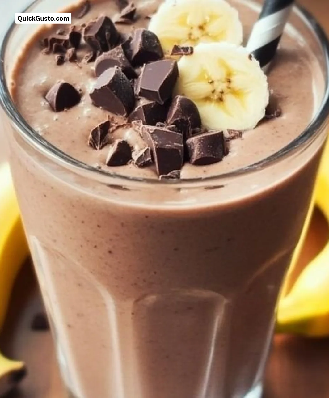 A delicious chocolate banana smoothie served in a glass with a banana slice on top