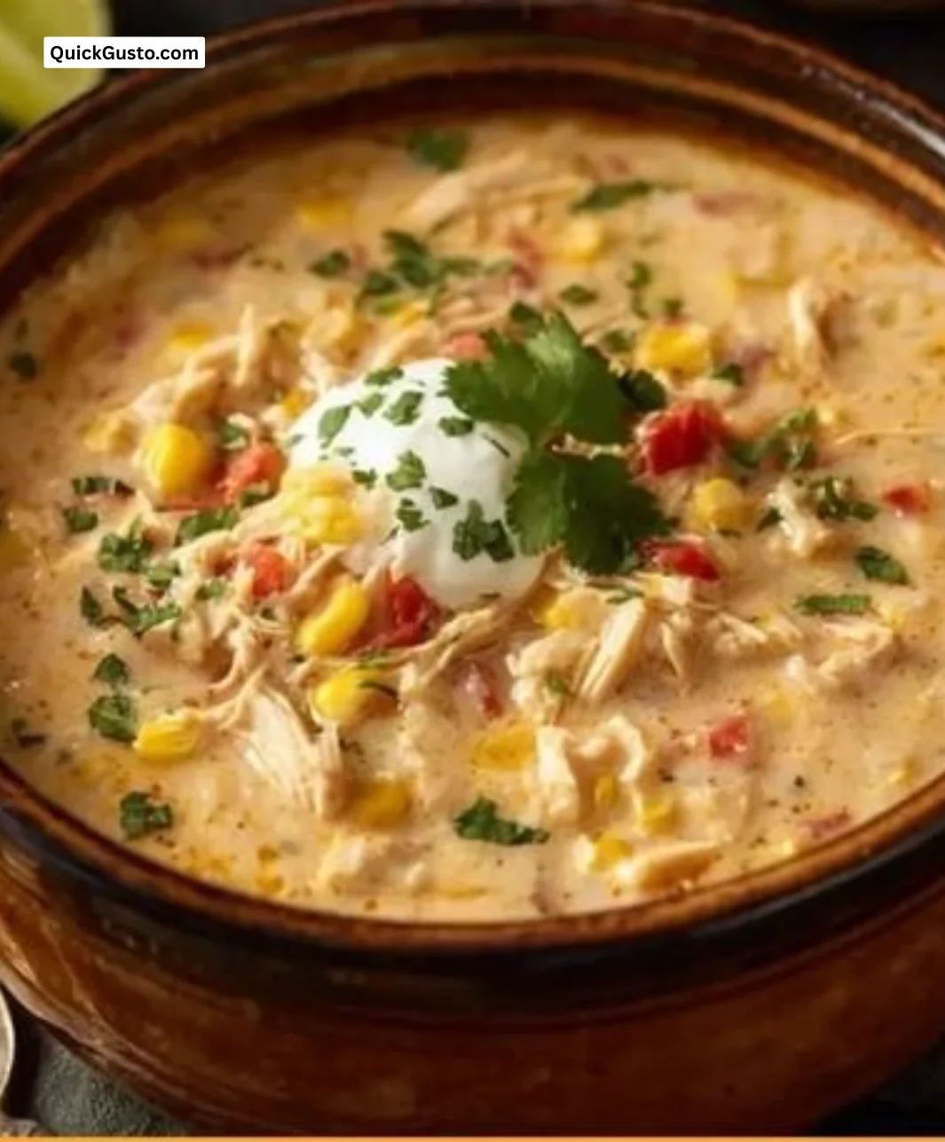 Delicious slow cooker chicken corn chowder garnished with herbs