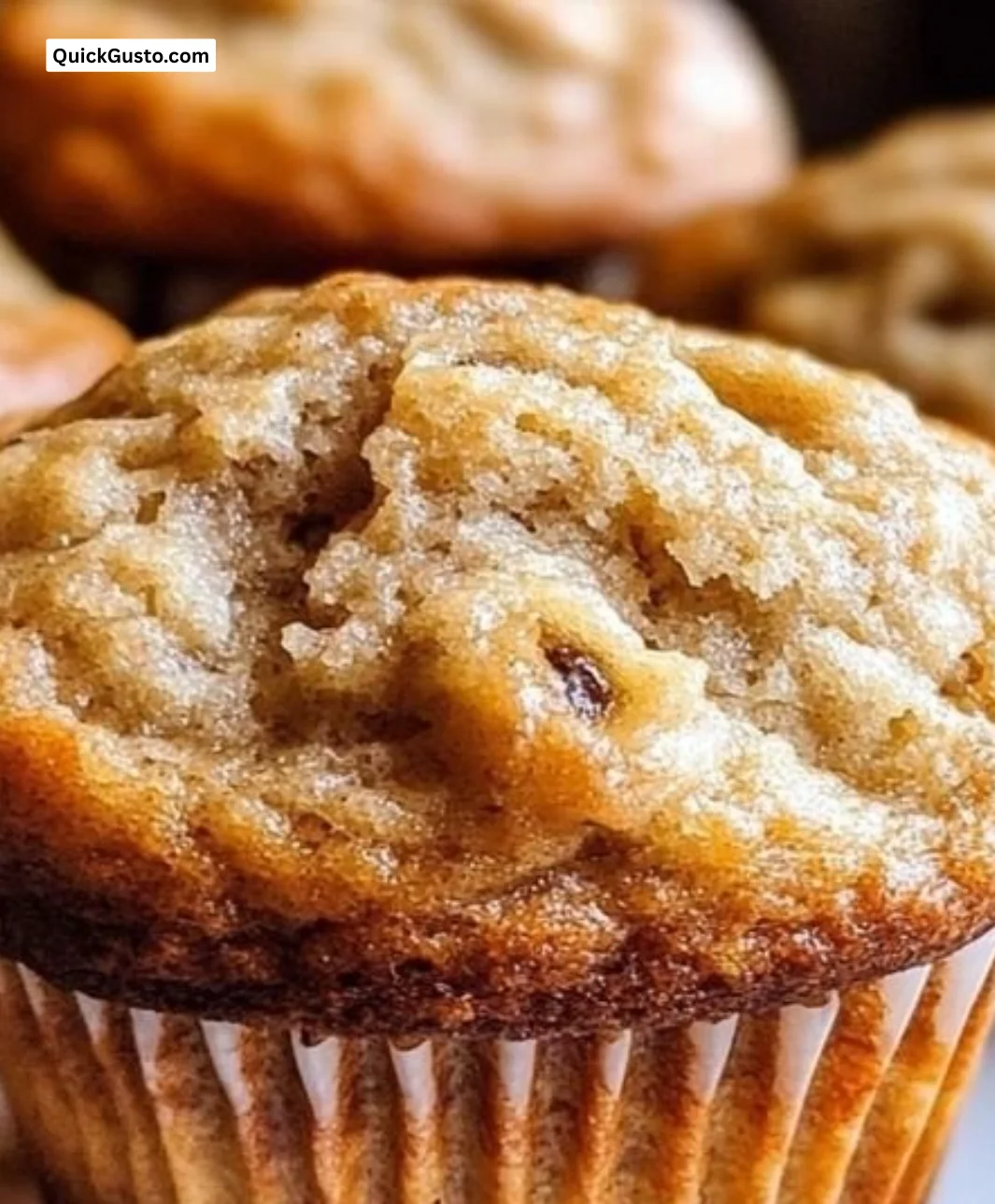 Freshly baked soft and fluffy banana muffins on a cooling rack.