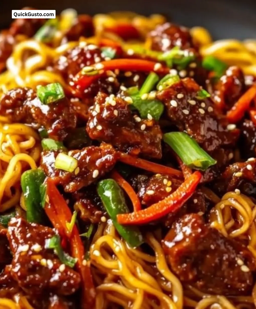 Delicious sticky beef noodles served in a bowl, garnished with fresh herbs.