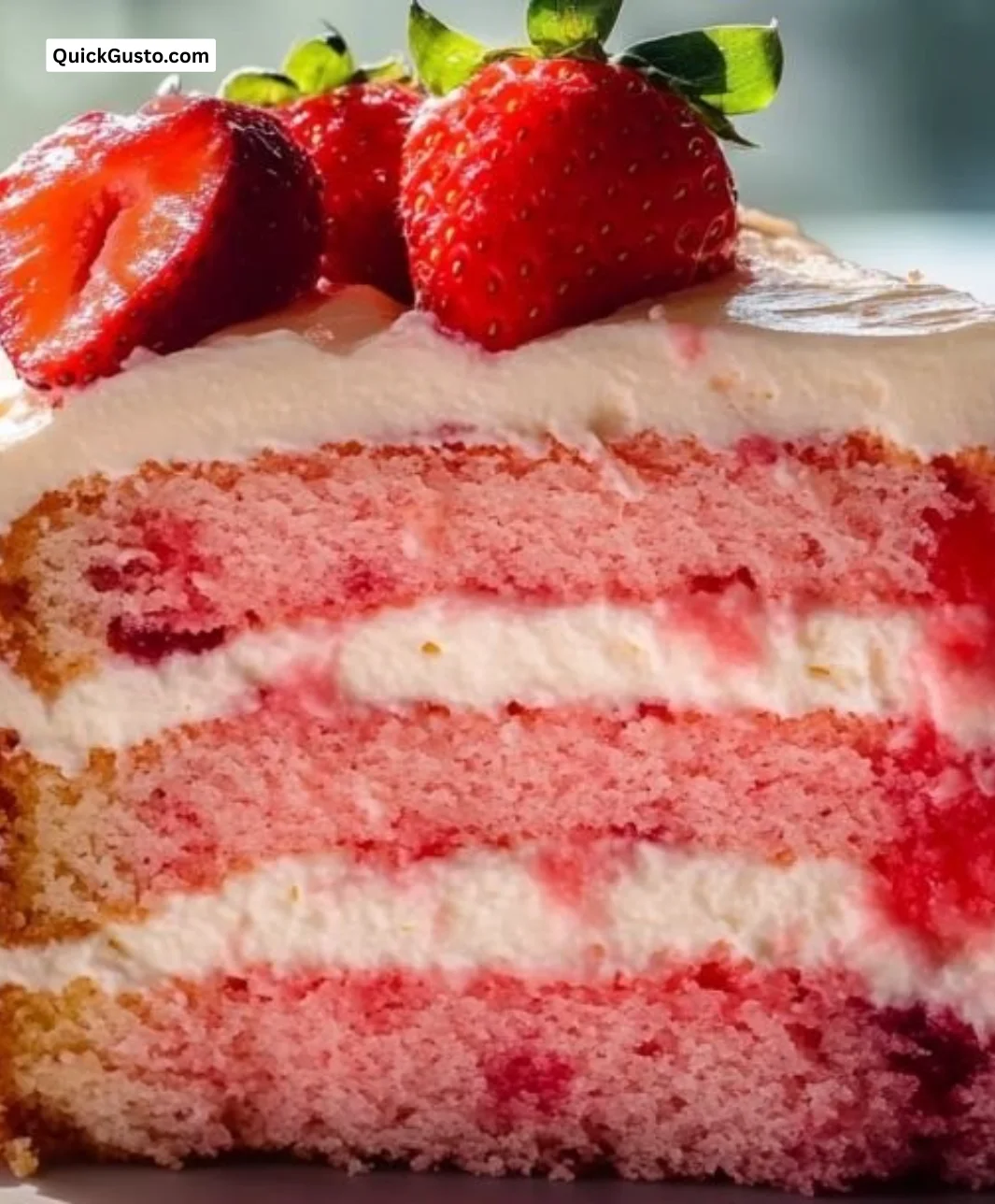 Delicious homemade Strawberry Box Cake topped with fresh strawberries and cream