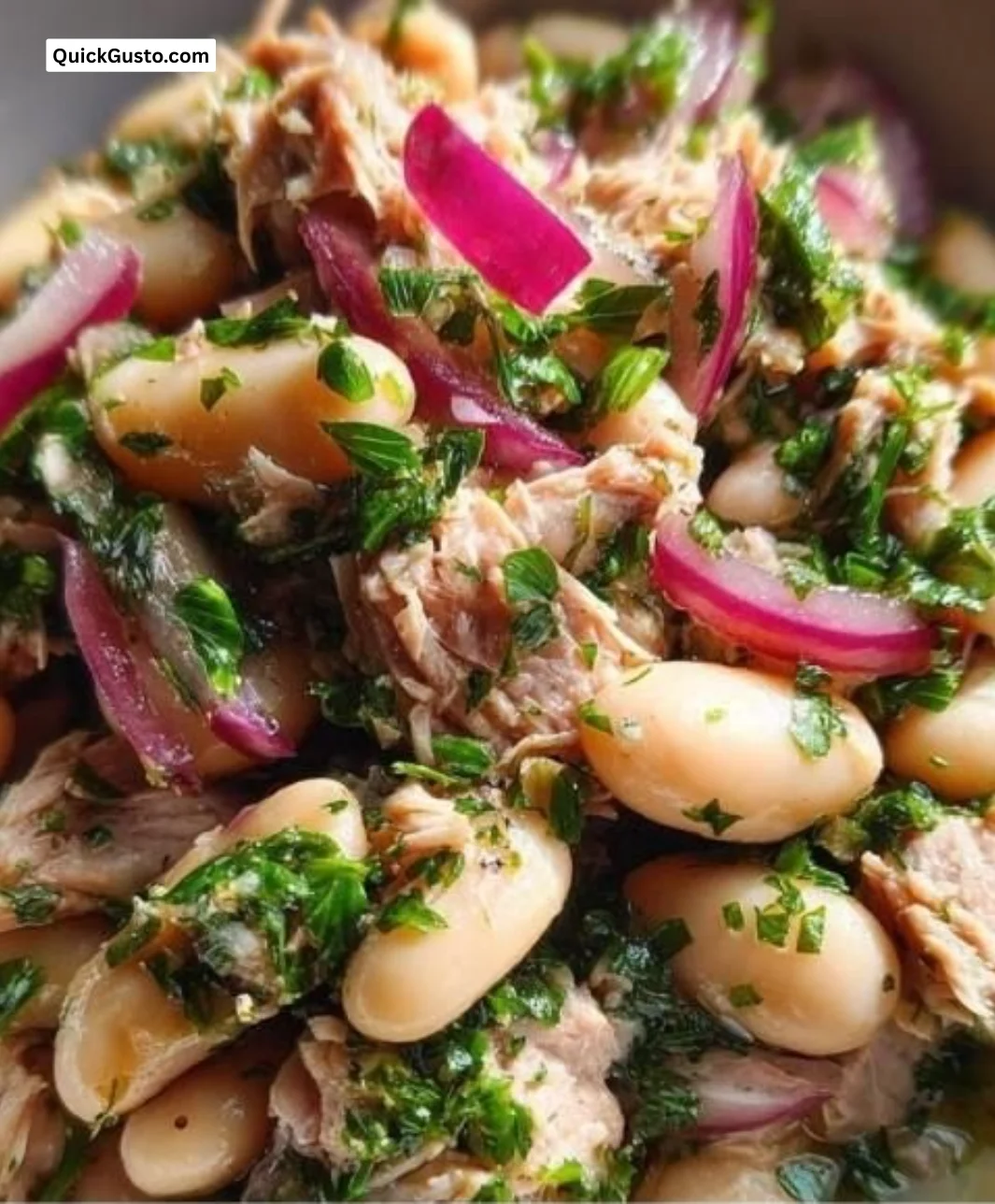 Tuna and white bean salad served in a bowl with fresh ingredients.