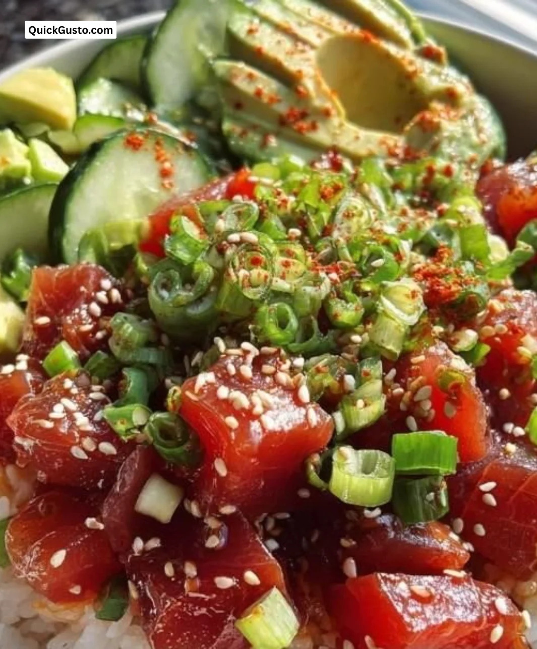 A colorful Tuna Poke Bowl topped with fresh vegetables and sesame seeds.