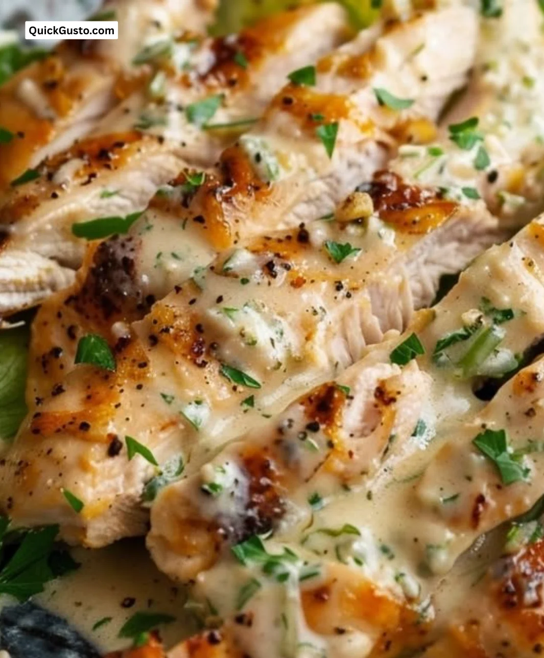 Baked Caesar Chicken dish served with crispy romaine and Caesar dressing