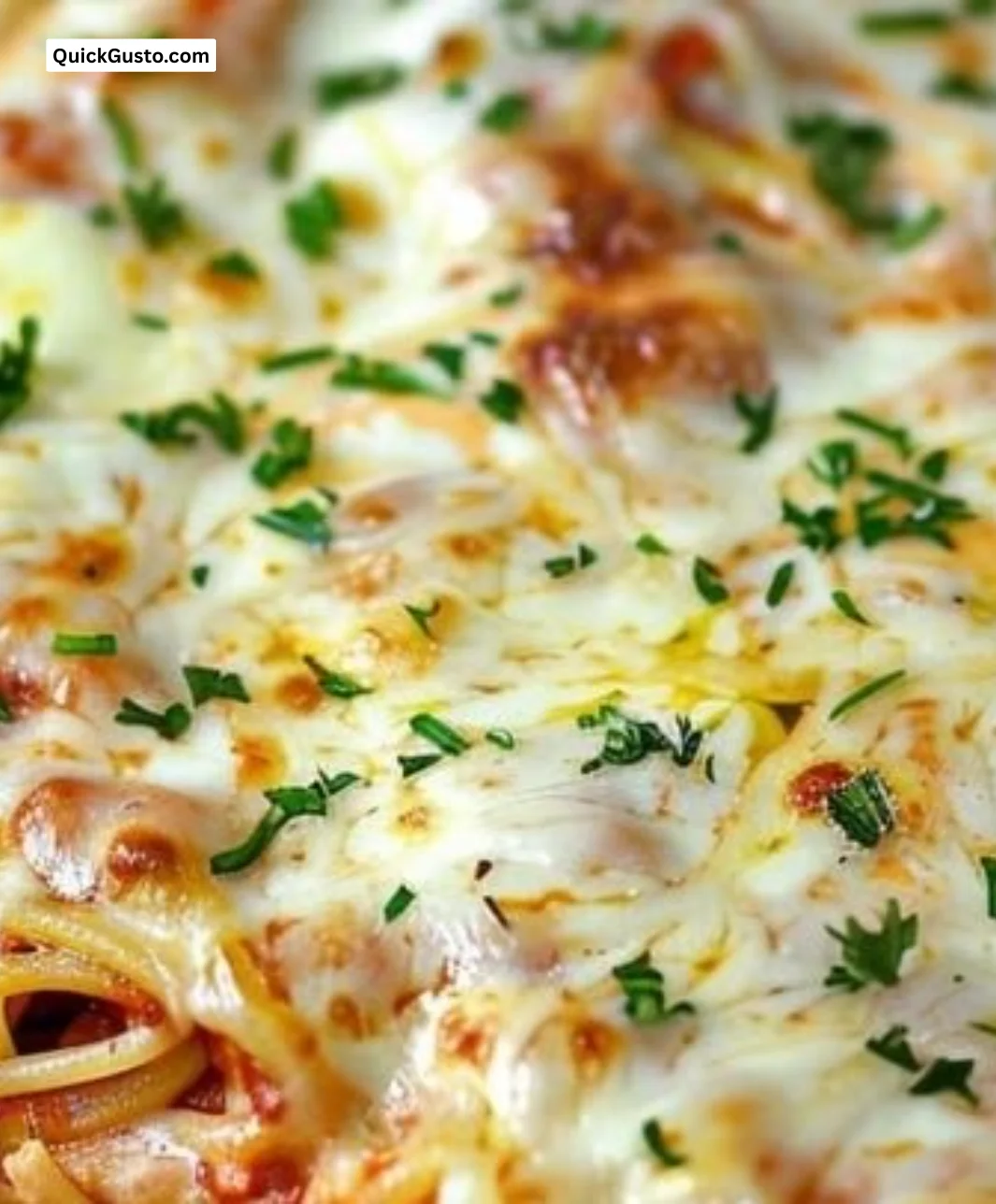 Baked Cream Cheese Spaghetti Casserole served in a dish with melted cheese on top
