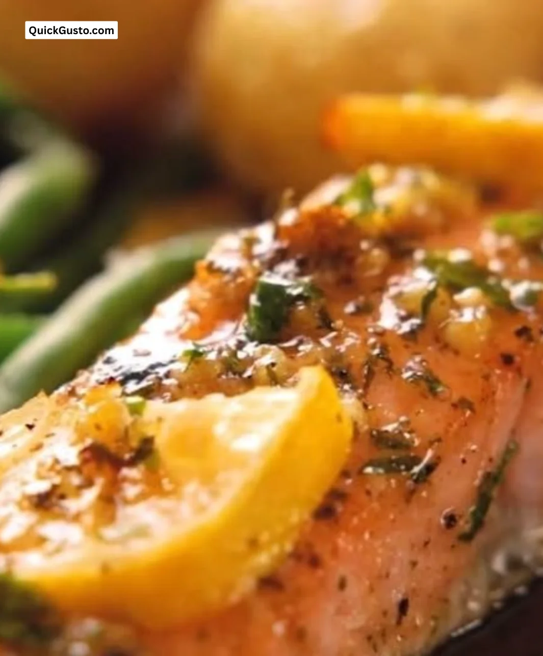 Perfectly baked salmon on a plate with herbs and lemon garnish